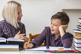 Teacher works closely with student to help him stay on track