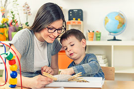 http://products.brookespublishing.com/The-DATA-Model-for-Teaching-Preschoolers-with-Autism-P992.aspx Smiling teacher works closely with student focusing on task at hand